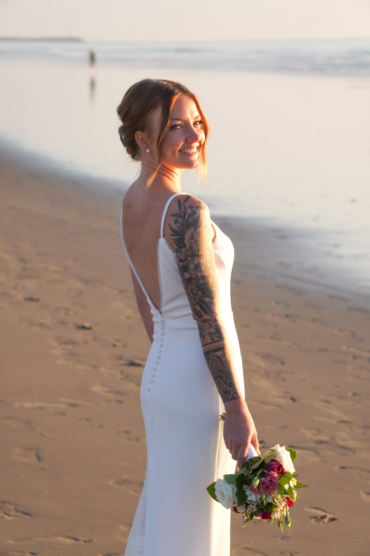 Bride portrait on the shoreline during an Oxnard, California beach wedding at sunset